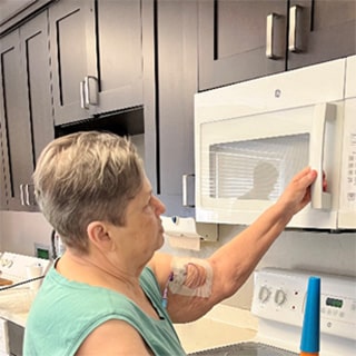Woman with short hair opening microwave