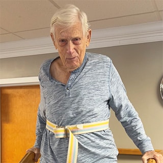 Man with tie belt on in rehab gym