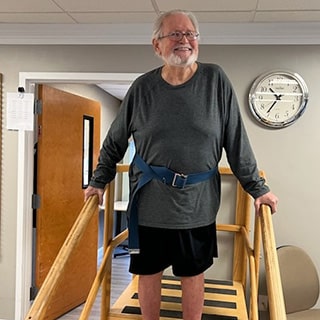 Man walking on bridge in rehab gym