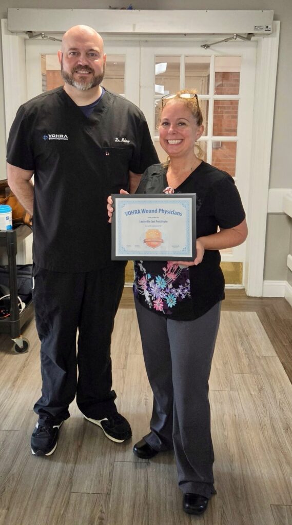 Vohra agent awarding Wound Care award to Louisville East's wound care nurse